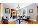 Bright living room featuring hardwood floors, a decorative fireplace, and large windows for natural light at 2227 N Ogden St, Denver, CO 80205