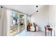 Bright sunroom with sliding glass doors that lead to a fenced backyard at 2227 N Ogden St, Denver, CO 80205