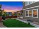 Beautifully landscaped backyard featuring a plush lawn, rock beds and a covered patio at 10003 Atlanta St, Parker, CO 80134
