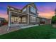 Stunning backyard featuring a covered patio, green lawn and fenced perimeter at 10003 Atlanta St, Parker, CO 80134