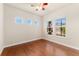 Bright bedroom features gleaming hardwood floors and multiple windows at 10003 Atlanta St, Parker, CO 80134
