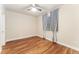 Cozy bedroom with a ceiling fan, wood-look flooring and a window with decorative gray drapes at 10003 Atlanta St, Parker, CO 80134