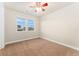 Neutral bedroom with carpet flooring, ceiling fan, and double windows providing natural light at 10003 Atlanta St, Parker, CO 80134