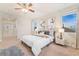 Sunlit bedroom showcasing large windows, modern lighting, carpet floors, and stylish decor at 10003 Atlanta St, Parker, CO 80134