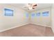 Bedroom with plush carpet, modern ceiling fan, and bright windows at 10003 Atlanta St, Parker, CO 80134