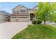 Charming two-story home with a three car garage and lush front lawn at 10003 Atlanta St, Parker, CO 80134