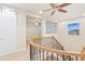 Upstairs landing with decorative staircase and barn door access at 10003 Atlanta St, Parker, CO 80134
