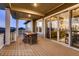 Relaxing outdoor porch with dining set, sliding glass doors, and views of the home's interior at 14111 Blue Stem St, Broomfield, CO 80020