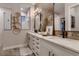 Double sink bathroom vanity with bronze accents and decorative wall decor above at 14111 Blue Stem St, Broomfield, CO 80020