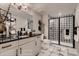 Modern bathroom featuring a double vanity, a walk-in shower with patterned tile, and contemporary fixtures at 14111 Blue Stem St, Broomfield, CO 80020