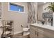 Neutral colored powder bathroom with modern fixtures, stylish vanity, and eye-catching decor at 14111 Blue Stem St, Broomfield, CO 80020
