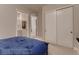 Comfortable bedroom showcasing a large closet with sliding doors and a glimpse into an ensuite bathroom at 14111 Blue Stem St, Broomfield, CO 80020