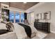 Well-lit primary bedroom with a view of the bathroom and scenic outdoor views at 14111 Blue Stem St, Broomfield, CO 80020