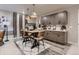 Elegant dining space with custom cabinets, wine racks, and chic lighting over a modern table set at 14111 Blue Stem St, Broomfield, CO 80020