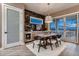 Dining area with marble accent wall, a stylish light fixture, and sliding door access to outdoor deck at 14111 Blue Stem St, Broomfield, CO 80020