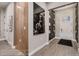 Inviting entryway with a decorative wall mirror, light hardwood floors, and an elegant patterned wallpaper at 14111 Blue Stem St, Broomfield, CO 80020