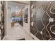 Hallway with an accent wall and decorative mirrors leading to living room area of the house at 14111 Blue Stem St, Broomfield, CO 80020