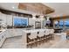 Open kitchen with modern cabinetry, stainless appliances, a large island, and wooden beam ceiling at 14111 Blue Stem St, Broomfield, CO 80020