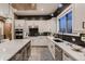 Modern kitchen with an island, stainless steel appliances, stylish countertops, and dark wood accents at 14111 Blue Stem St, Broomfield, CO 80020