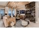 Stylish living room featuring a marble fireplace, wood ceiling, and large windows with views at 14111 Blue Stem St, Broomfield, CO 80020