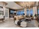 Open-concept living room with a modern fireplace, wood ceiling, and access to an outdoor deck at 14111 Blue Stem St, Broomfield, CO 80020