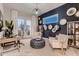 Bright office with a stylish accent wall, unique light fixture, and sliding glass doors to the outdoors at 14111 Blue Stem St, Broomfield, CO 80020