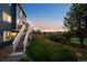 Spacious backyard with grass and stairs up to the house at 10103 Knoll Cir, Highlands Ranch, CO 80130