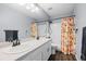 Bright bathroom showcasing a double sink vanity, new fixtures, and a tiled shower/tub at 10103 Knoll Cir, Highlands Ranch, CO 80130