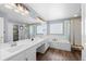 Luxury bathroom featuring double sinks, a soaking tub, and a glass-enclosed shower at 10103 Knoll Cir, Highlands Ranch, CO 80130