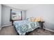 Cozy bedroom with a queen-size bed, a window for natural light, and soft neutral accents at 10103 Knoll Cir, Highlands Ranch, CO 80130