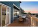 Comfortable deck with outdoor dining and seating area at twilight at 10103 Knoll Cir, Highlands Ranch, CO 80130