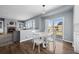 Open dining area features a modern table set, access to the deck, and flows into the cozy living space at 10103 Knoll Cir, Highlands Ranch, CO 80130