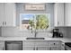 Bright kitchen featuring white cabinetry, sleek countertops, and modern fixtures at 10103 Knoll Cir, Highlands Ranch, CO 80130