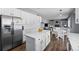 Bright kitchen boasts an island, stainless steel appliances, white cabinets, and flows into an eating area at 10103 Knoll Cir, Highlands Ranch, CO 80130