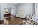 Sunlit living room with hardwood floors and a dining area in an open-concept design at 10103 Knoll Cir, Highlands Ranch, CO 80130