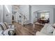 Bright open-concept living area featuring hardwood floors and elegant lighting at 10103 Knoll Cir, Highlands Ranch, CO 80130