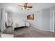 Comfortable main bedroom with a large bed, ceiling fan and modern decor at 10103 Knoll Cir, Highlands Ranch, CO 80130