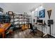 Well-decorated office/music room with instruments and book shelves by the window at 10103 Knoll Cir, Highlands Ranch, CO 80130
