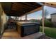 Covered patio with a hot tub and access to backyard at 10103 Knoll Cir, Highlands Ranch, CO 80130