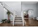 Inviting foyer showcasing a staircase with plush carpeting and an adjacent dining room at 10103 Knoll Cir, Highlands Ranch, CO 80130