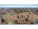 An aerial view showcases the community park featuring tennis courts and a playground at 12550 Maria Cir, Broomfield, CO 80020