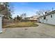 Open backyard area with small patch of grass, wood fence, and the house in the background at 12550 Maria Cir, Broomfield, CO 80020