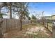 Backyard with a tall wood fence separating the property line and a small tree in the yard at 12550 Maria Cir, Broomfield, CO 80020