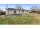 Backyard view shows wood deck with pergola, solar panels on the roof, and grass at 12550 Maria Cir, Broomfield, CO 80020