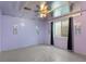 Finished basement area with window, dark curtains, concrete floor, and overhead ceiling fan at 12550 Maria Cir, Broomfield, CO 80020