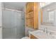 Updated bathroom featuring tiled walk-in shower and wooden vanity with marble countertop at 12550 Maria Cir, Broomfield, CO 80020