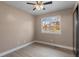 Cozy bedroom featuring a ceiling fan and a window with a view of the neighborhood at 12550 Maria Cir, Broomfield, CO 80020