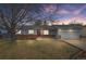 Beautiful single-story home with light blue siding, brick accents, and a large tree in the front yard at 12550 Maria Cir, Broomfield, CO 80020