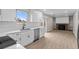 Modern kitchen features white cabinets, stainless appliances, and an open layout to the living room fireplace at 12550 Maria Cir, Broomfield, CO 80020