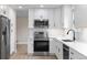 Modern kitchen with white cabinets, stainless steel appliances, and subway tile backsplash at 12550 Maria Cir, Broomfield, CO 80020